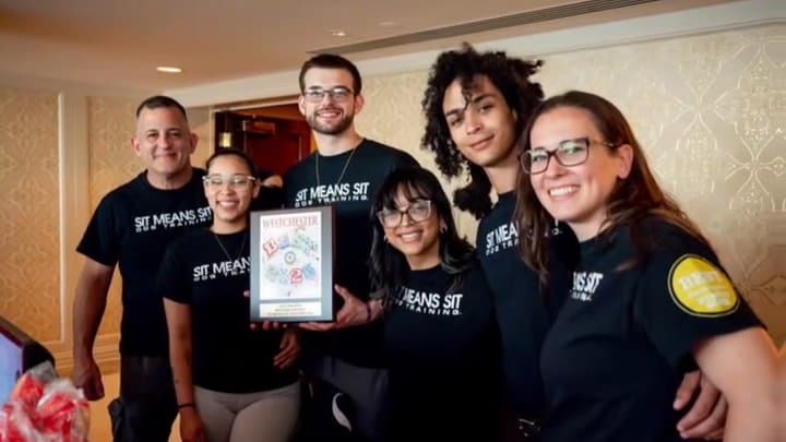 The Sit Means Sit Dog Training of Westchester team holding their Best of Westchester plaque